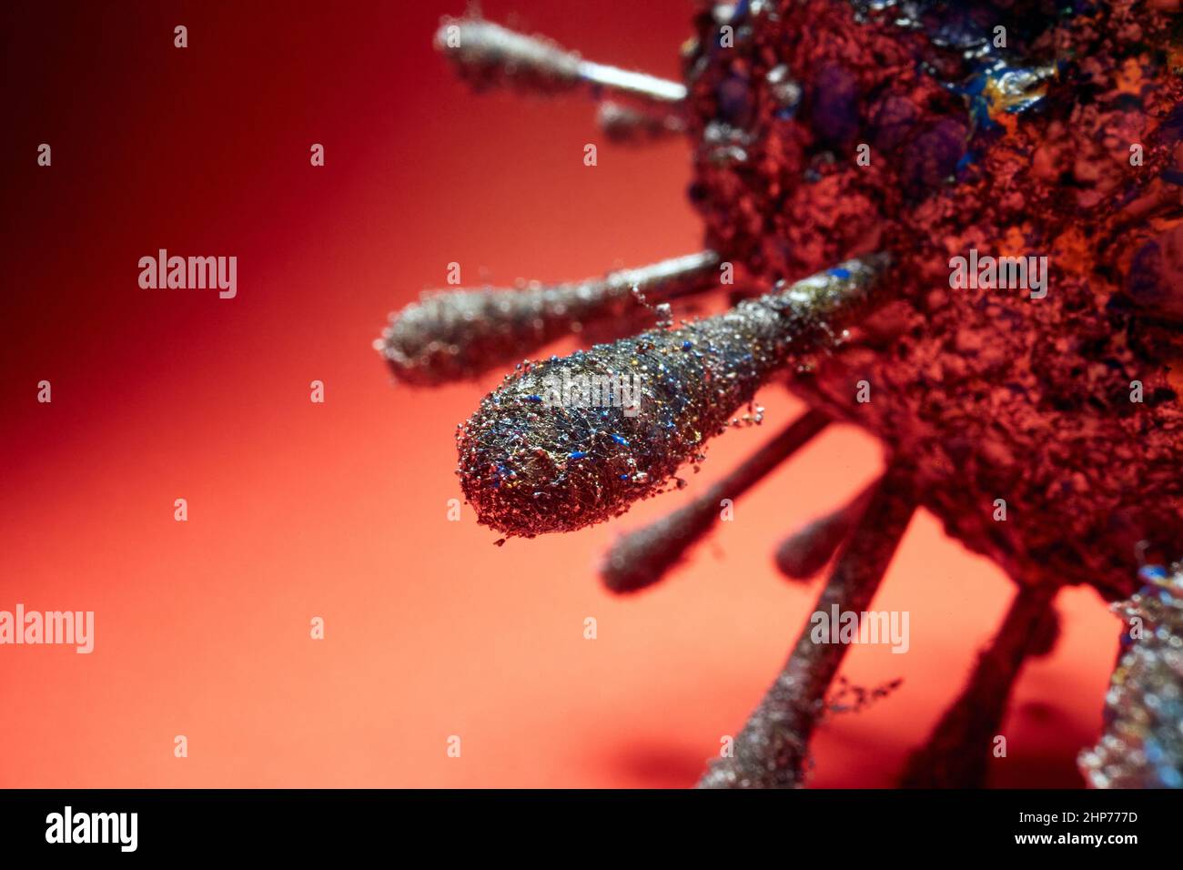 Mockup of the spike of Covid virus on the red background. Covid19, corona, pandemic Stock Photo