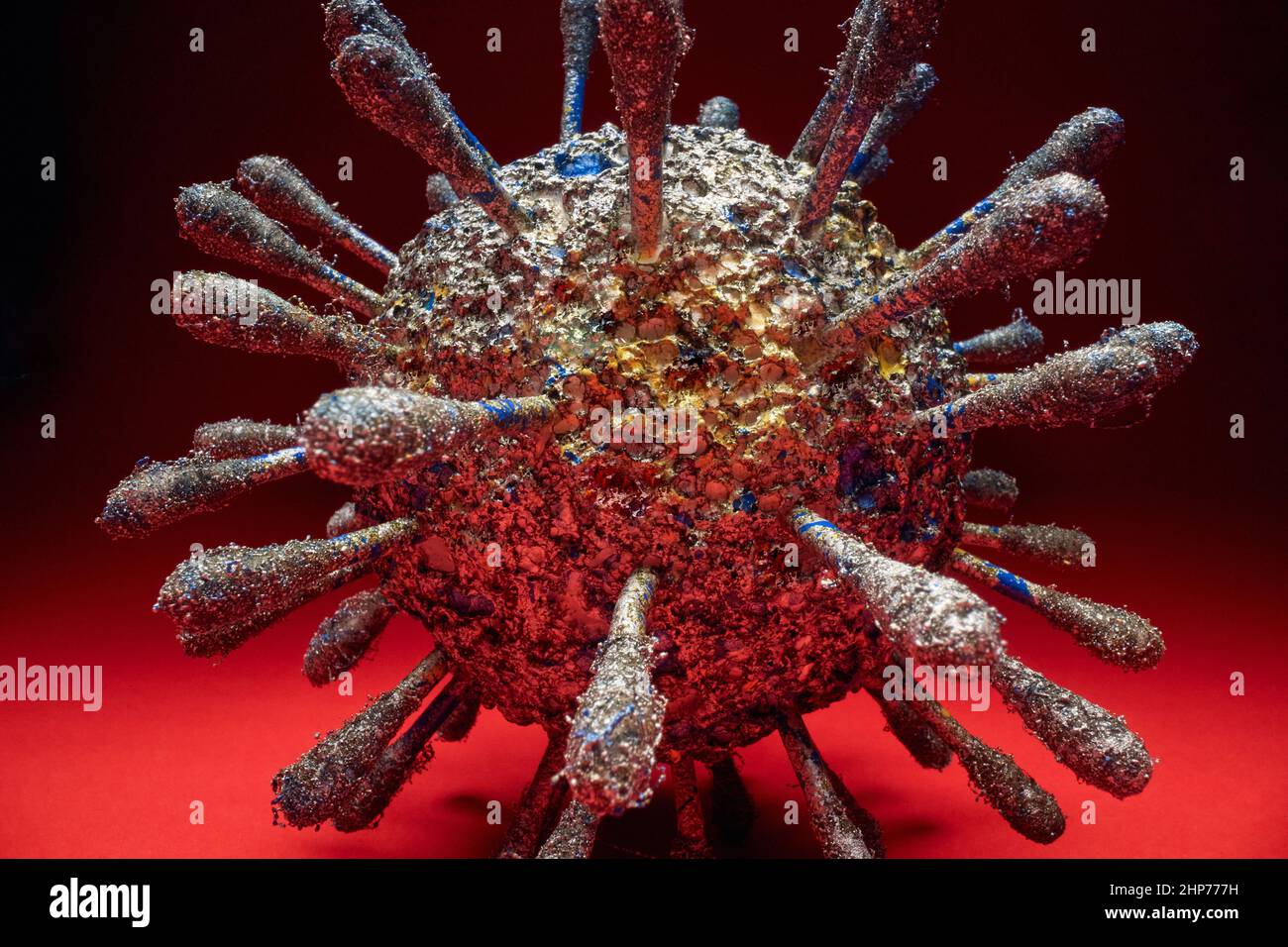 Model of a dangerous Covid virus on the red background. Covid19, corona, pandemic Stock Photo