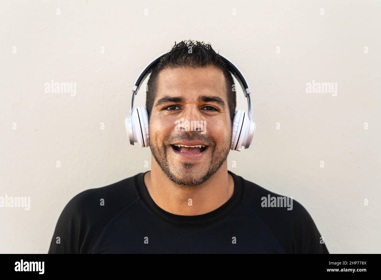 Hispanic man listening music with headphones outdoor Stock Photo