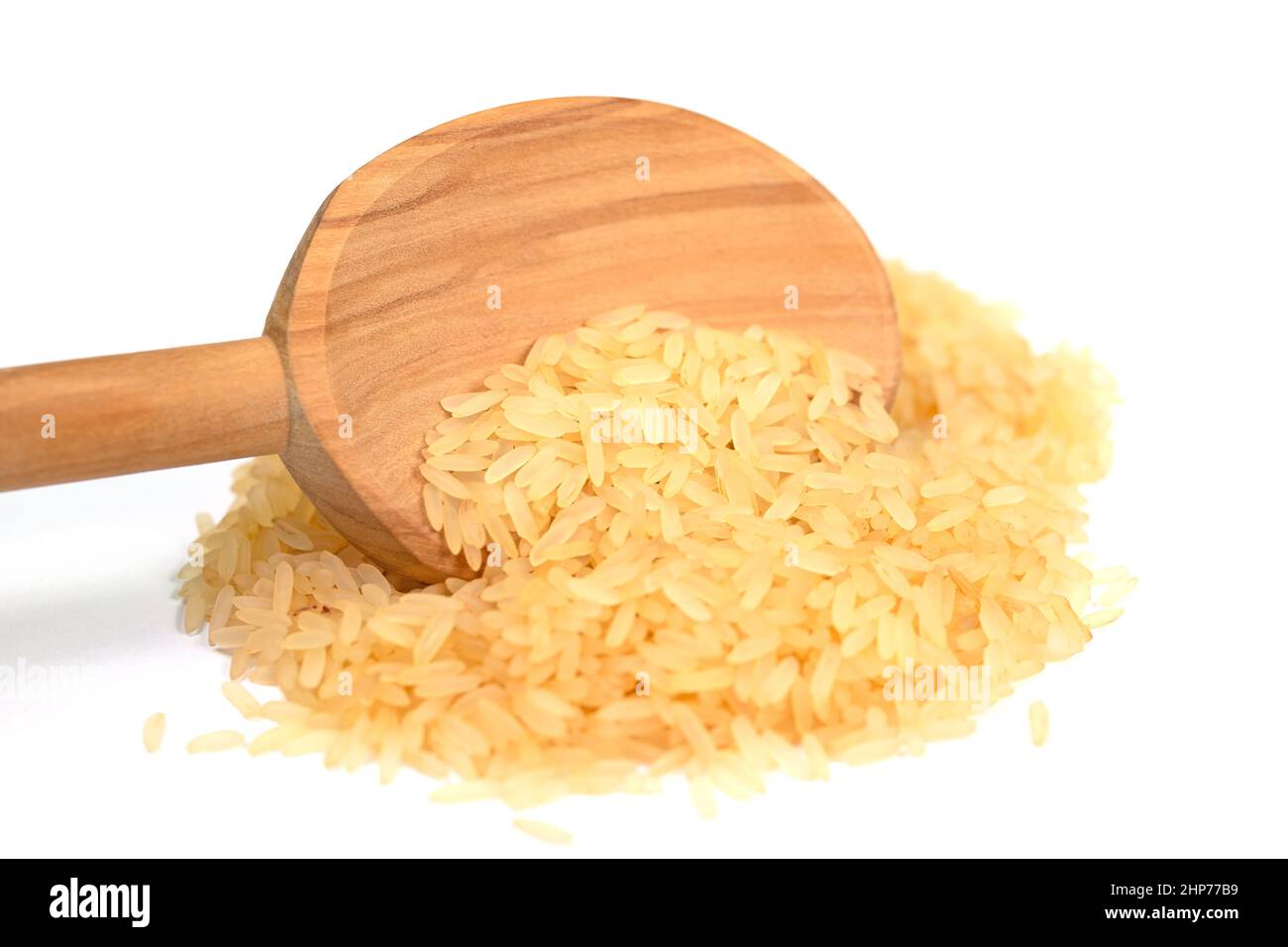 Rice grains and wooden spoon isolated against white background Stock ...