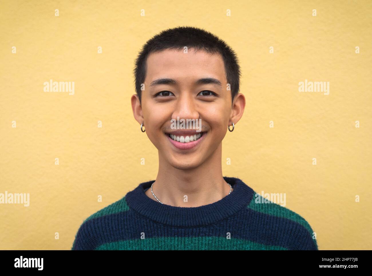 Portrait of happy young Asian teenager smiling in front of camera Stock Photo