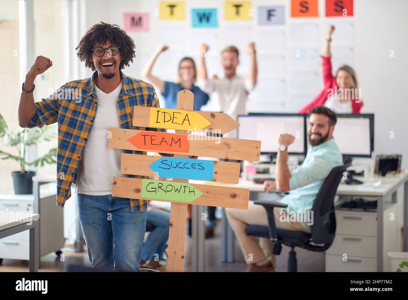 A young male office worker is promoting company slogans while posing