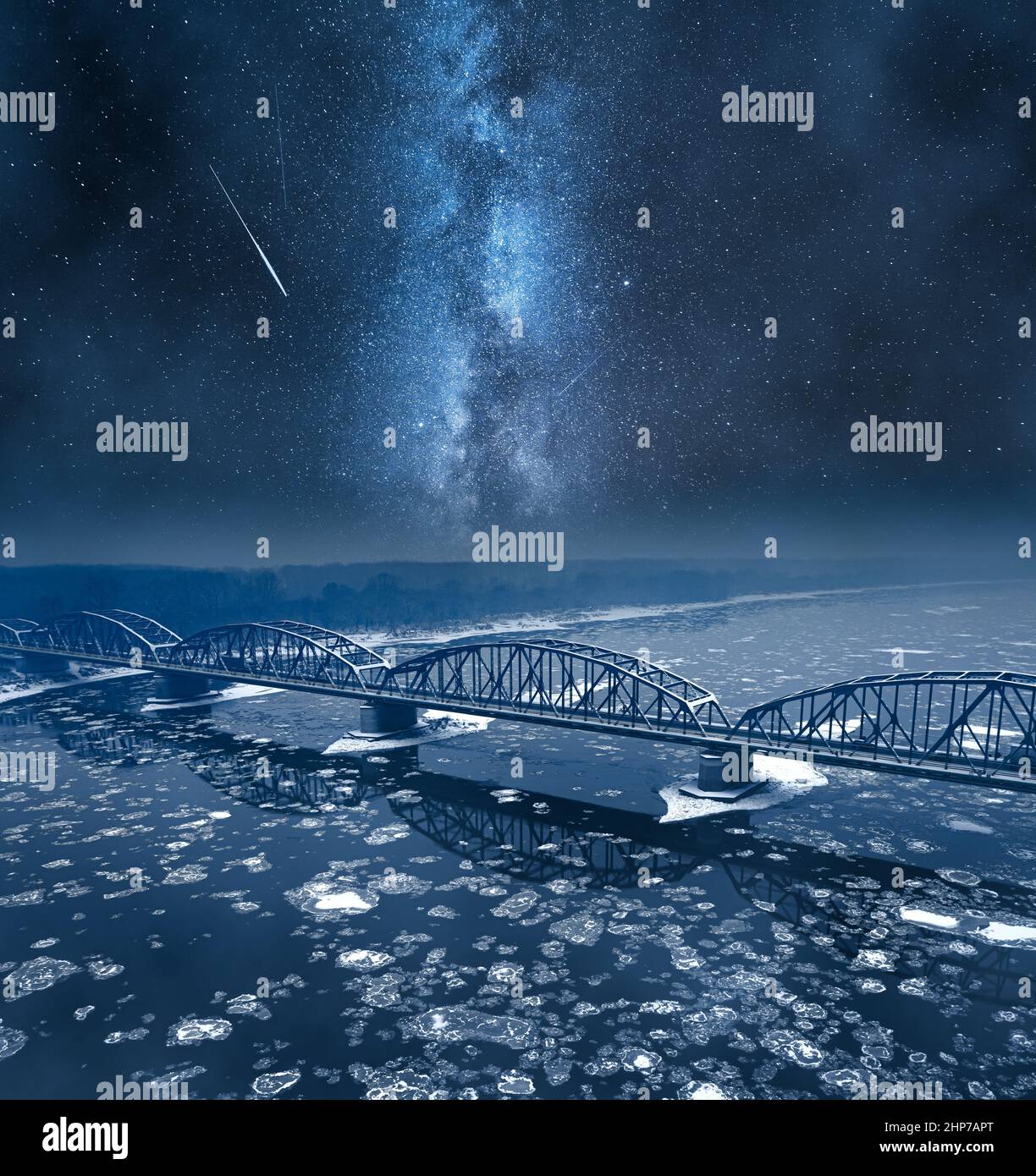 Milky way over river with floes and bridge in winter. Winter at night in Poland. Stock Photo