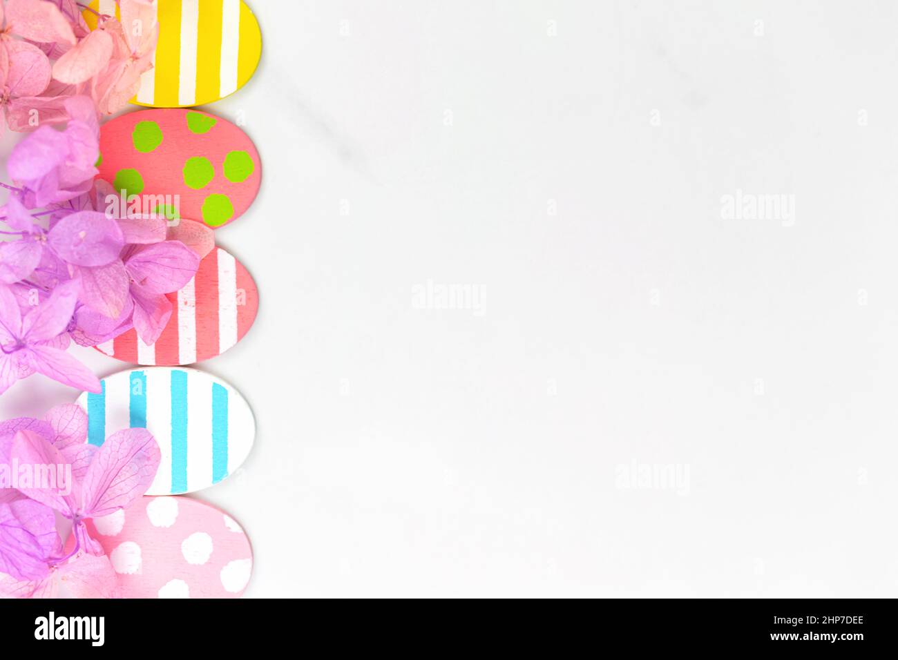 Colorful easter eggs and flowers. Border design with pink spring ...