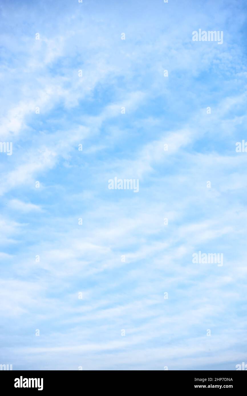 Light-blue sky with white clouds - vertical background Stock Photo