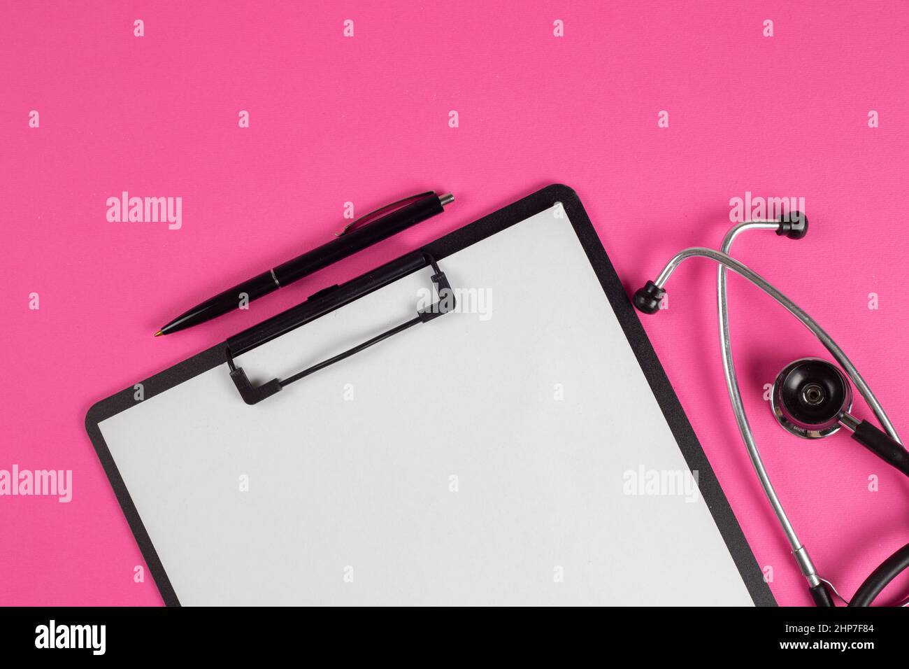 Treatment plan for a patient, doctor's desk top view. Stethoscope, note pad, medical concept Stock Photo