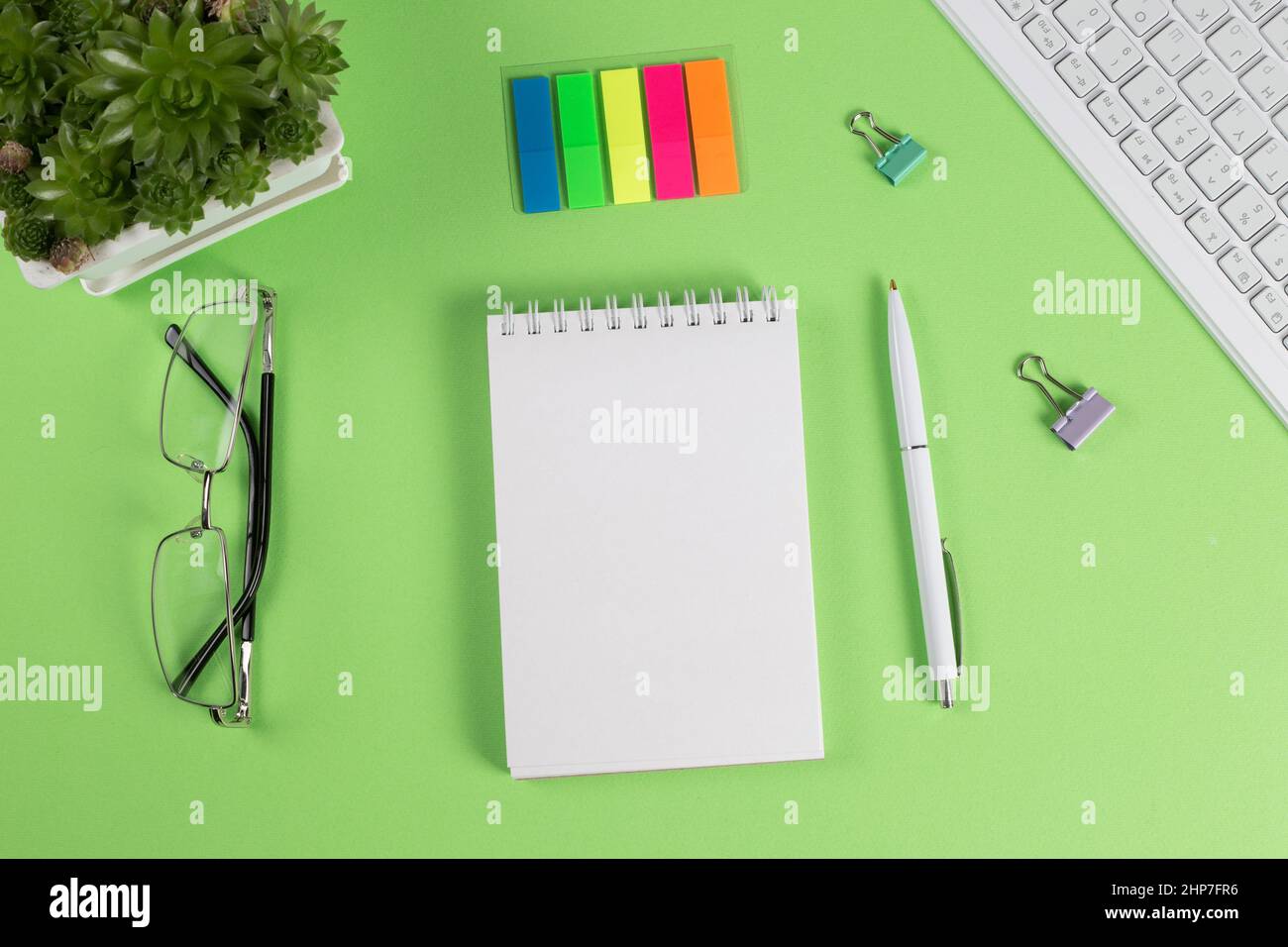 Open notepad with blank page on desktop, top view. Stock Photo