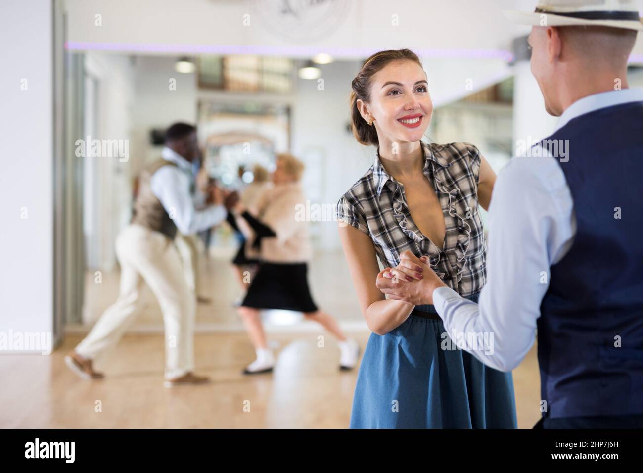 Cheerful Female Practicing Lindy Hop In Pair With Man Stock Photo - Alamy