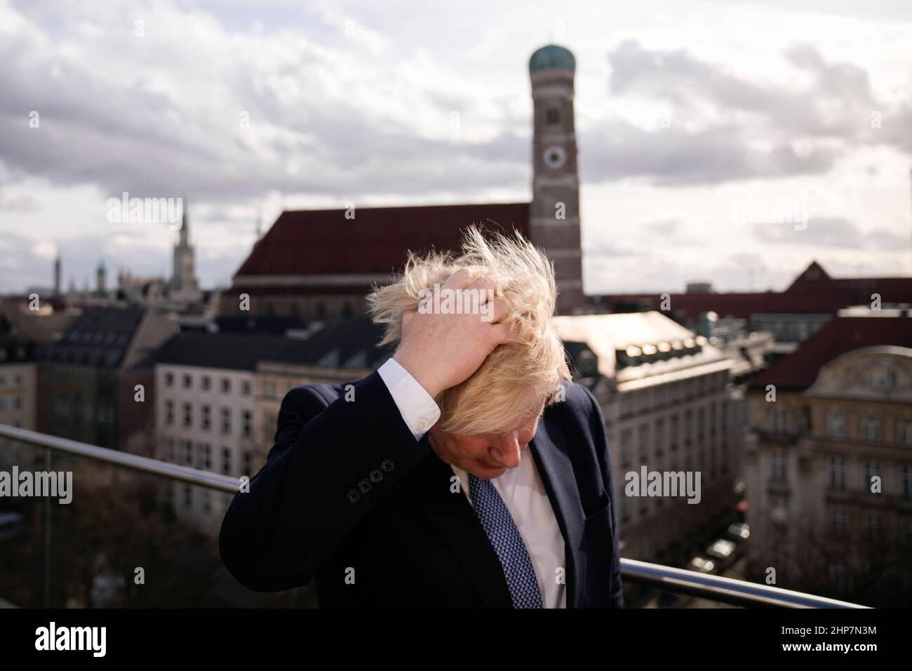 Prime Minister Boris Johnson rubbing his hair to get ready for a interview during the Munich Security Conference in Germany where he is meeting with world leaders to discuss tensions in eastern Europe. Picture date: Saturday February 19, 2022. Stock Photo