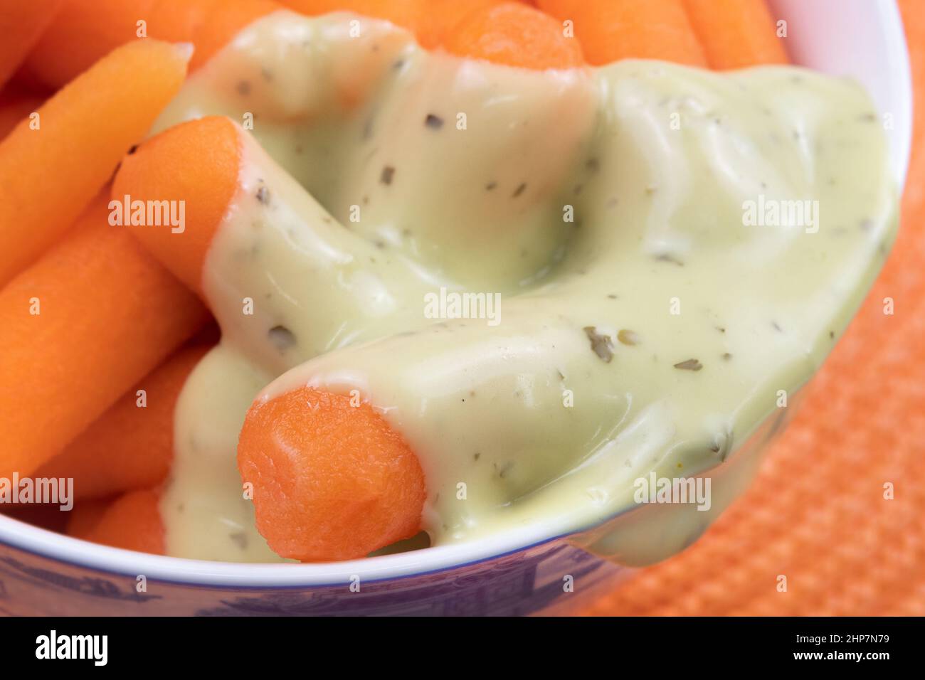 Baby carrots with avocado dipping sauce Stock Photo Alamy