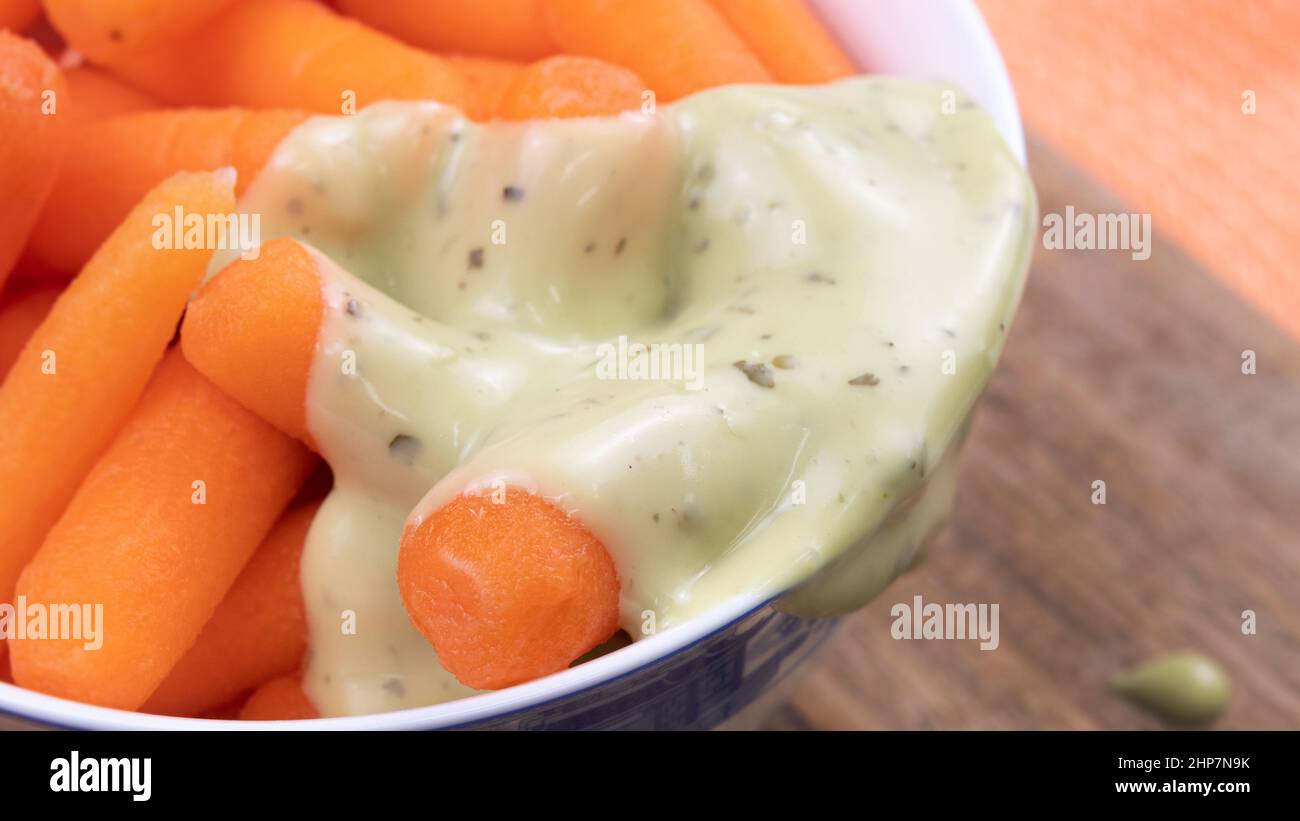 Baby carrots with avocado dipping sauce Stock Photo