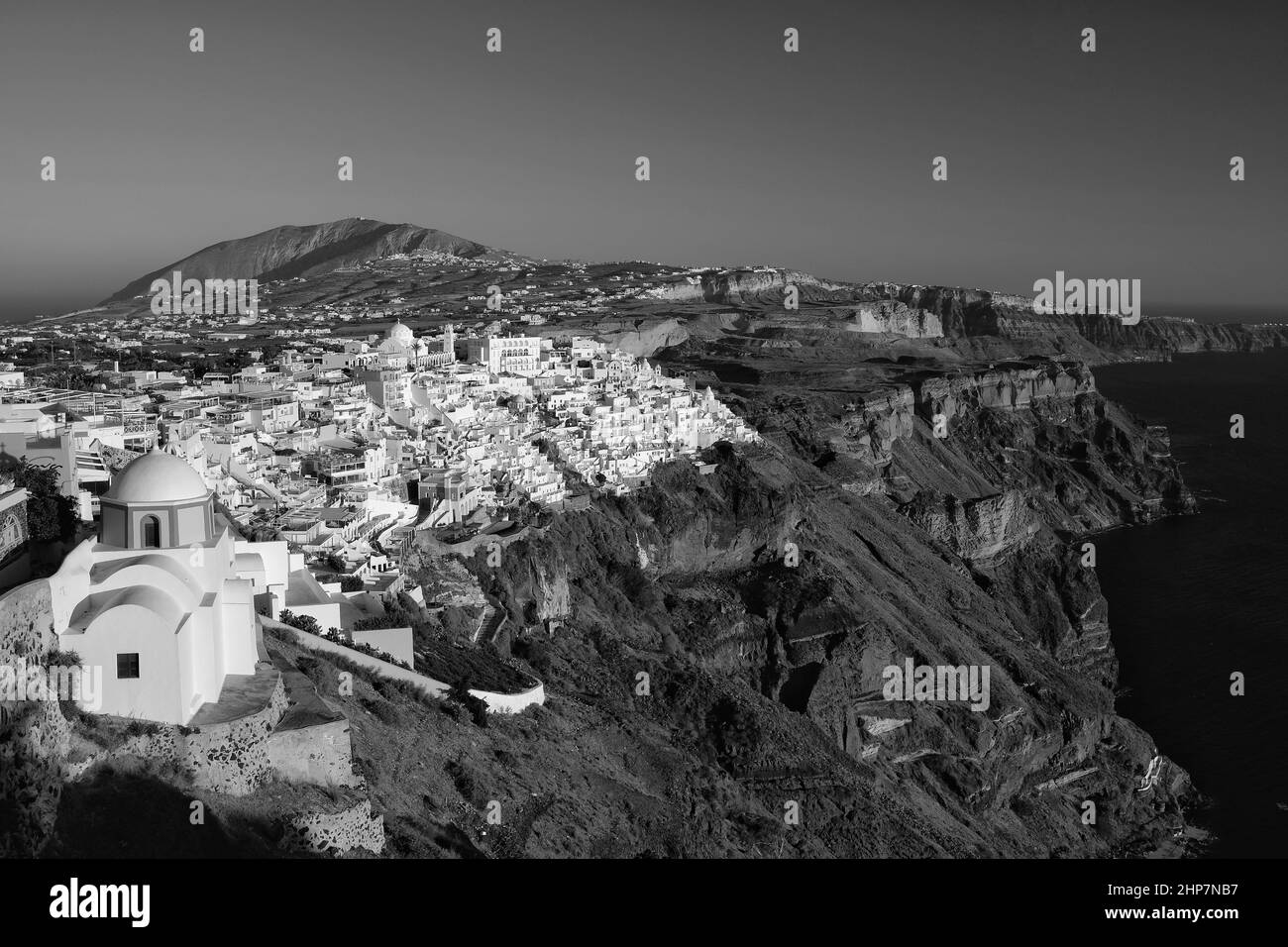 Panoramic view of the picturesque village of Fira Santorini and the Aegean Sea in black and white Stock Photo