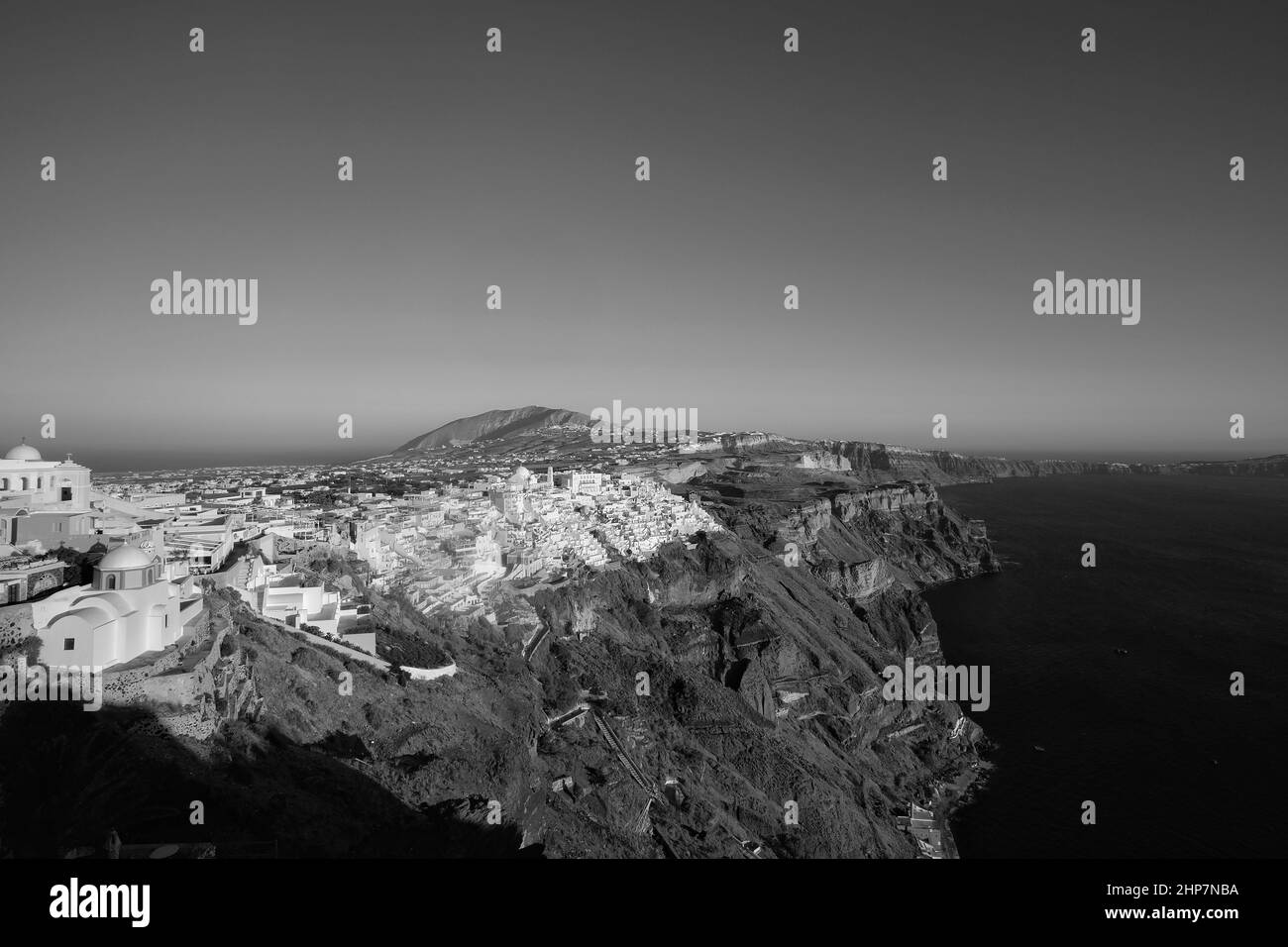 Panoramic view of the picturesque village of Fira Santorini and the Aegean Sea in black and white Stock Photo