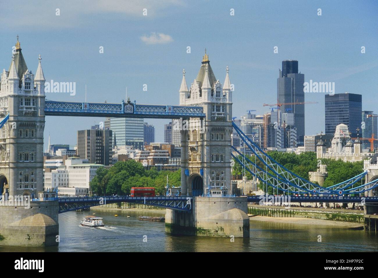 Tower Bridge, Tower of London and the skyscrapers of the financial city of London. England, UK. Circa 1980's Stock Photo