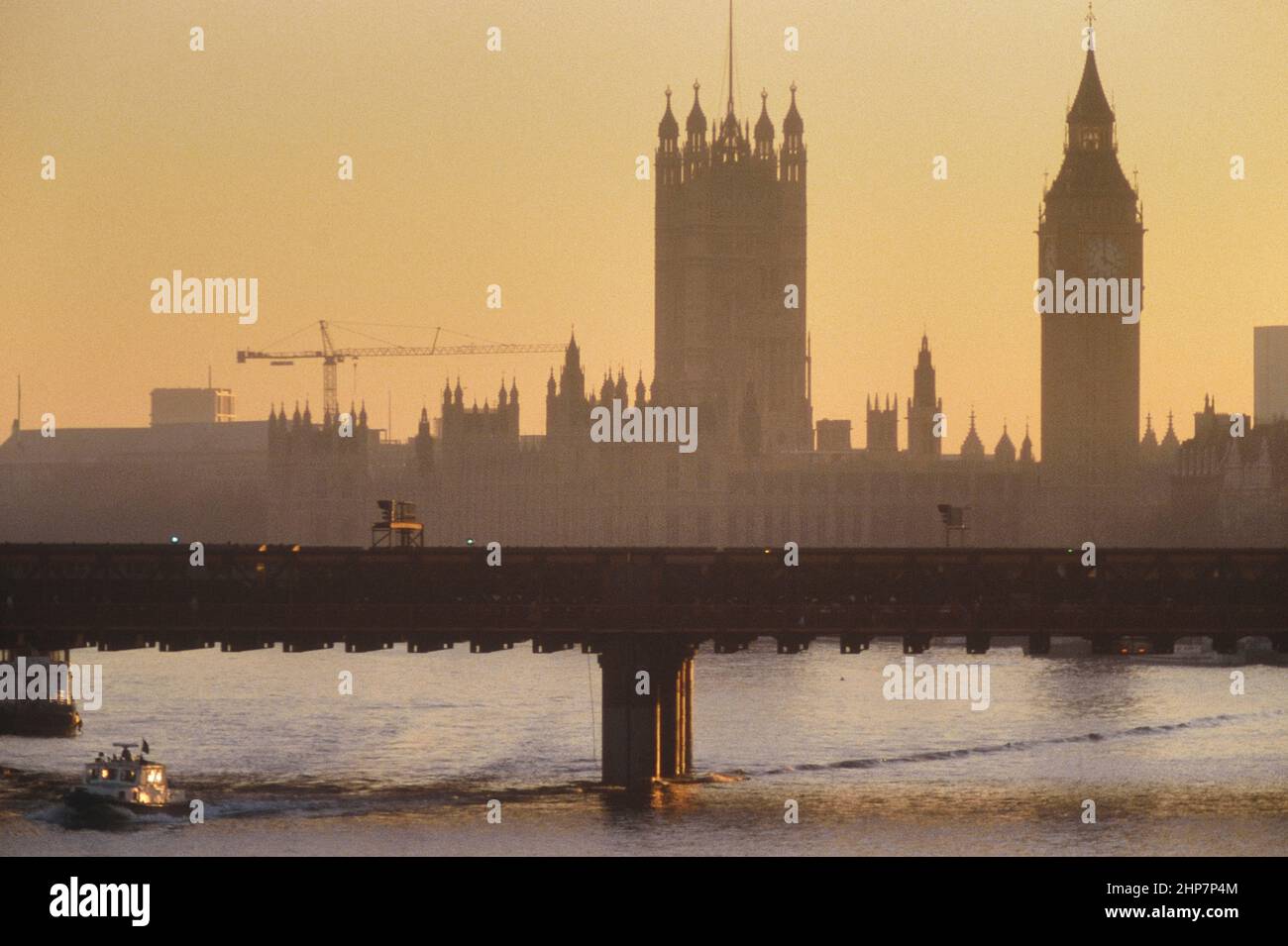 Hungerford Bridge and The Houses of Parliament, London, England, UK. Circa 1980's Stock Photo