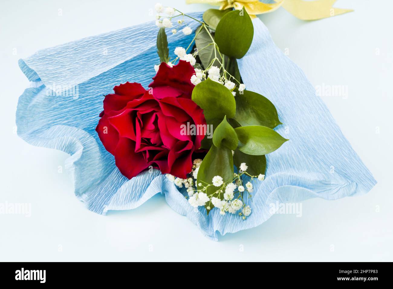 Stylish Bouquet Of Red Rose With Green Leaves In Blue Color Paper On White Surface Stock Photo Alamy
