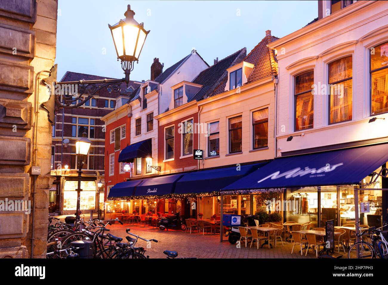 Night view to cafes and restaurants at the Markt, the largest historic market squares in Europe, located in Delft, South Holland, Netherlands Stock Photo