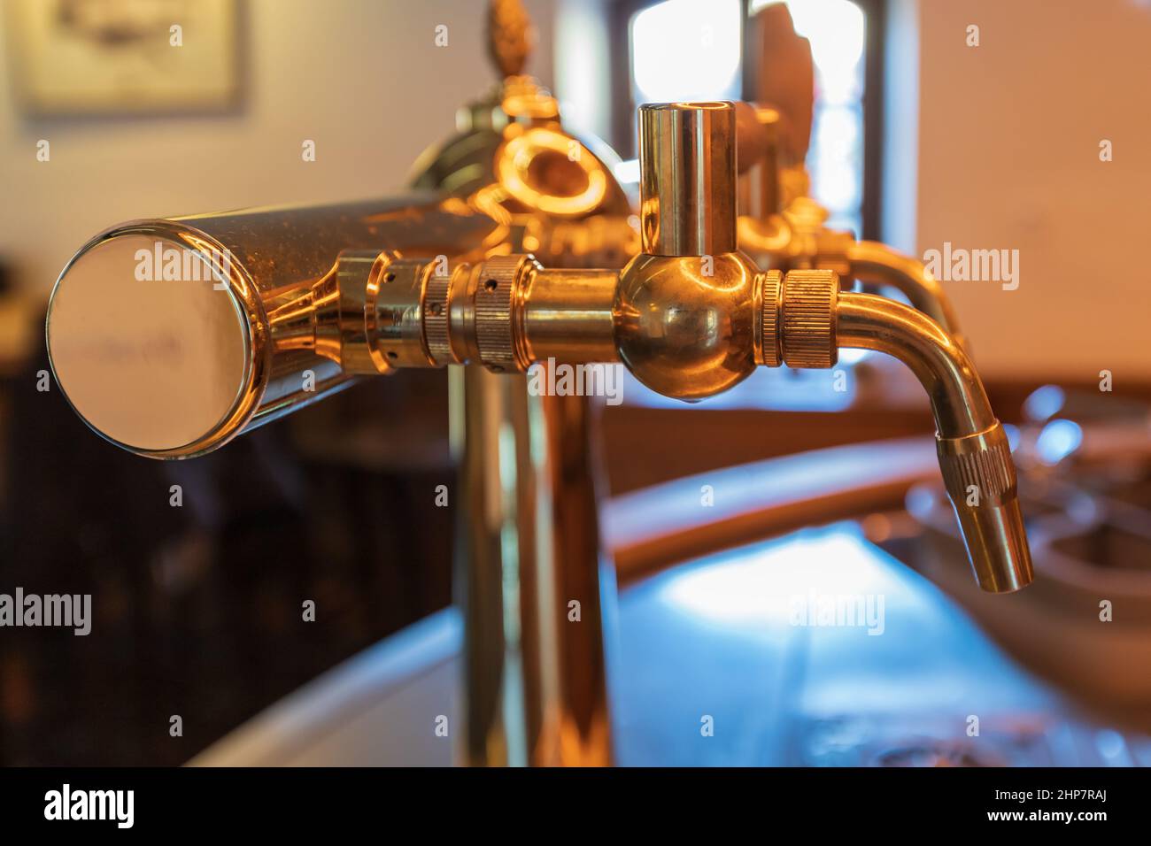 Beer tapping equipment in a restaurant. The background is blurred Stock
