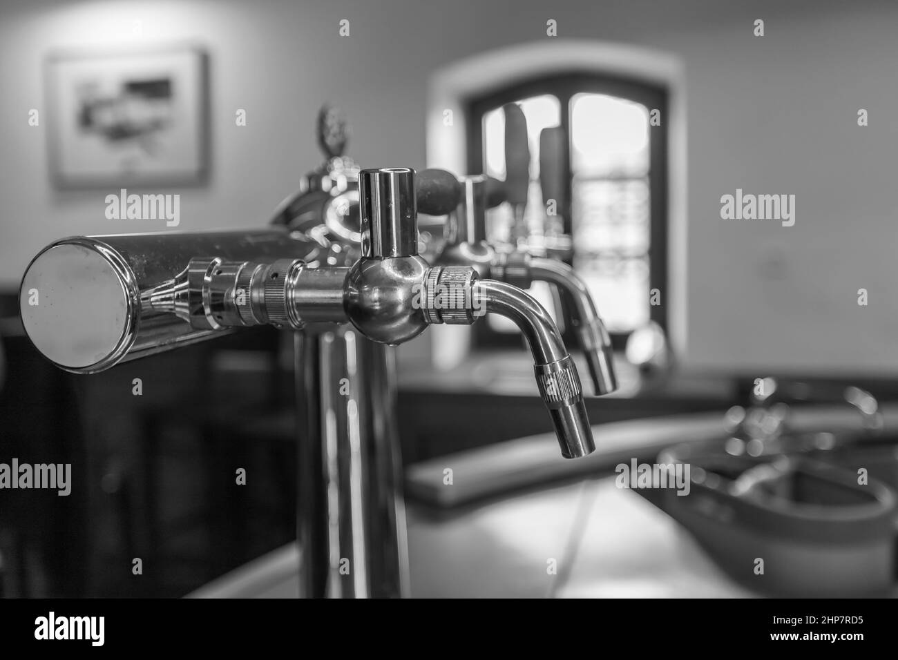 Beer tapping equipment in a restaurant. The background is blurred. Stock Photo