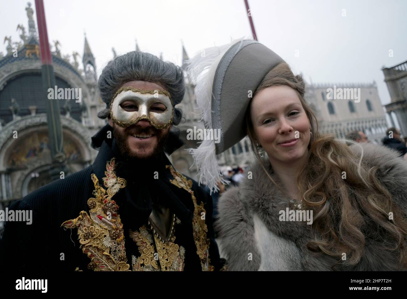 Masked revellers pose in St Mark's Square on February 20, 2022 in ...