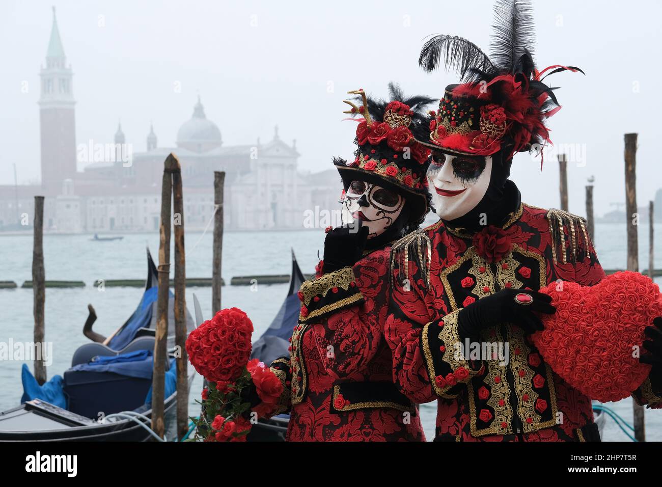 Masked revellers pose in St Mark's Square on February 20, 2022 in ...