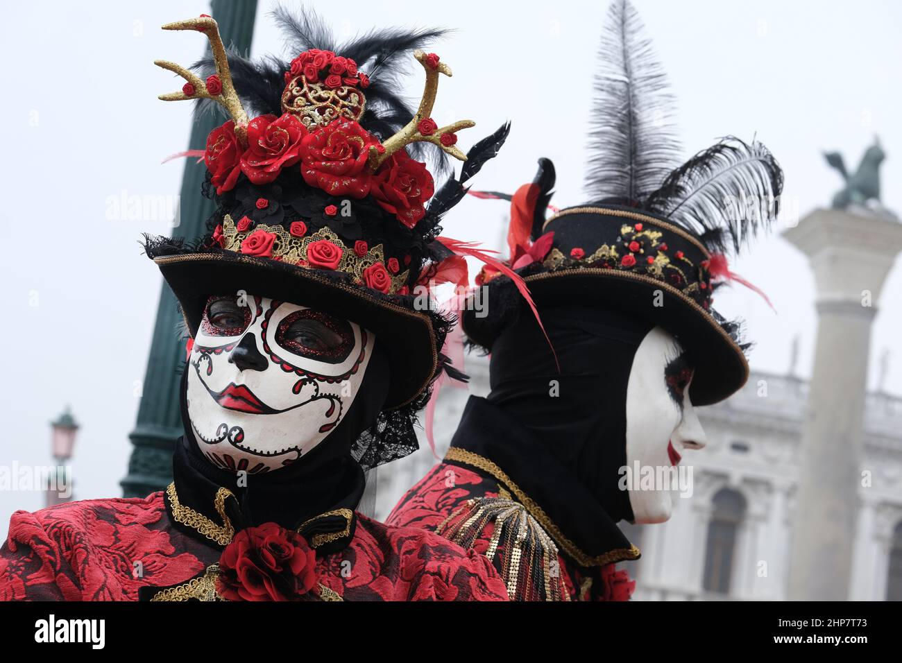 Masked revellers pose in St Mark's Square on February 20, 2022 in ...