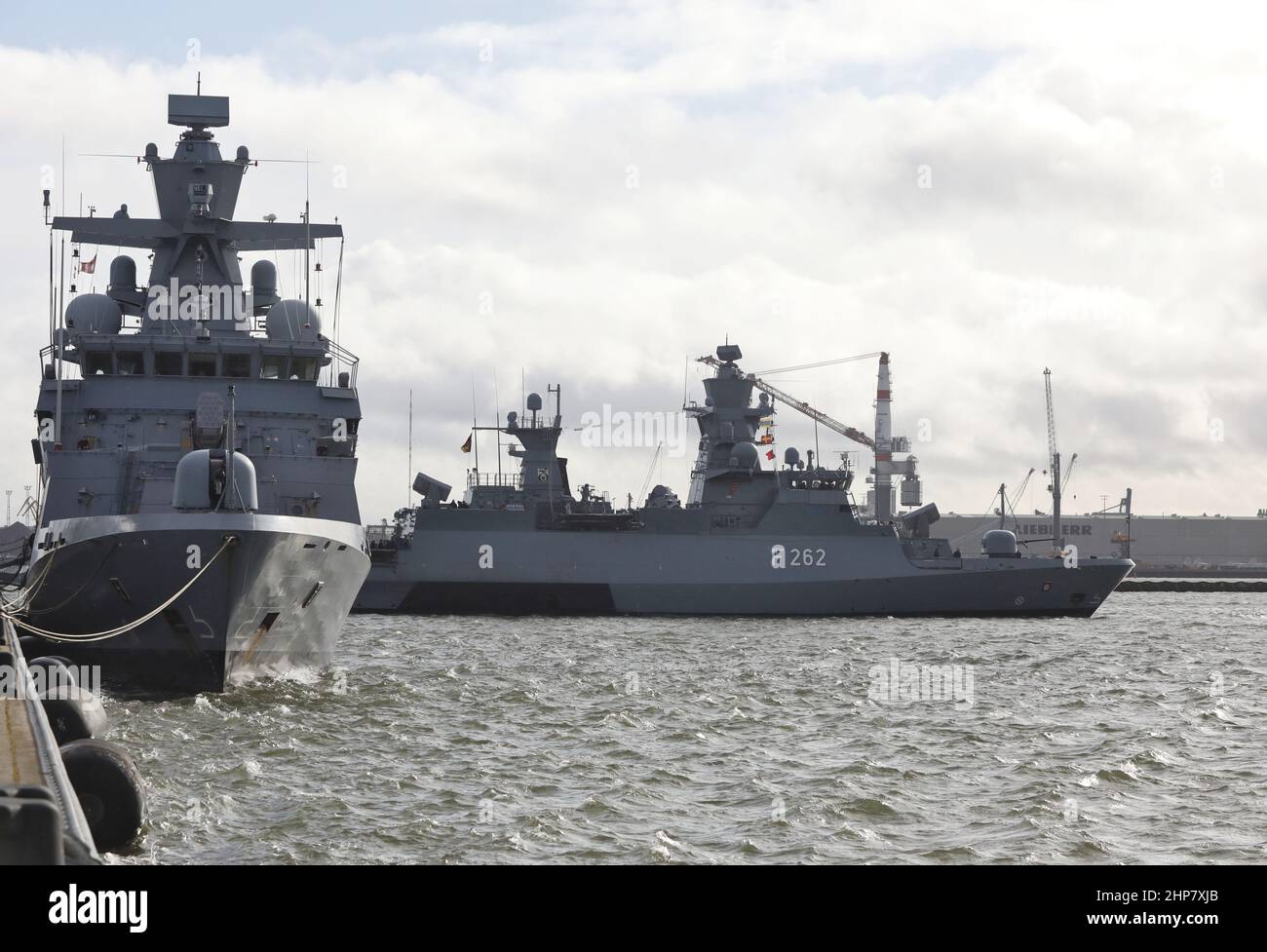 19 February 2022, Mecklenburg-Western Pomerania, Warnemünde: The corvette 'Erfurt' (r) casts off in the harbor of the Hohe Düne naval base. The corvette 'Erfurt' sets off for the Mediterranean. As part of the UN mission UNIFIL, the ship is to help off the Lebanese coast, among other things, to prevent arms smuggling into Lebanon, according to the German Navy. The mission is scheduled to last five months, and the ship with its 63-member crew is also to support the training of the Lebanese navy. Photo: Danny Gohlke/dpa Stock Photo
