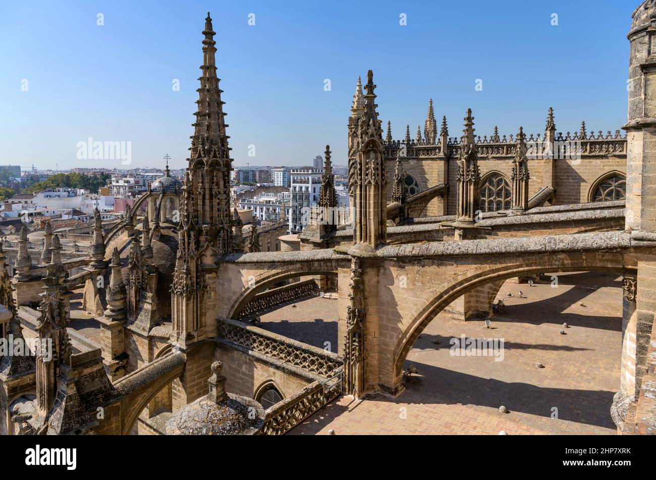 Seville Cathedral - A wide-angle view of architectural elements - pinnacles, buttresses and flying buttresses on roof of Seville Cathedral, Spain. Stock Photo
