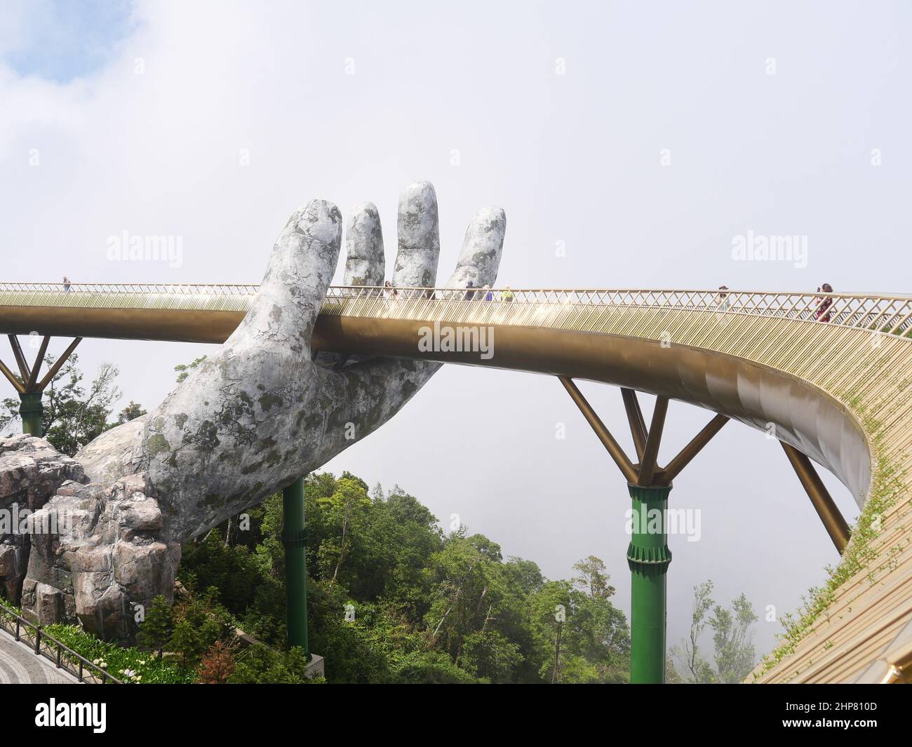 Da Nang, Vietnam - April 12, 2021: Golden Bridge lifted by giant hands in Ba Na Hills, a famous theme park and resort in Central Vietnam Stock Photo