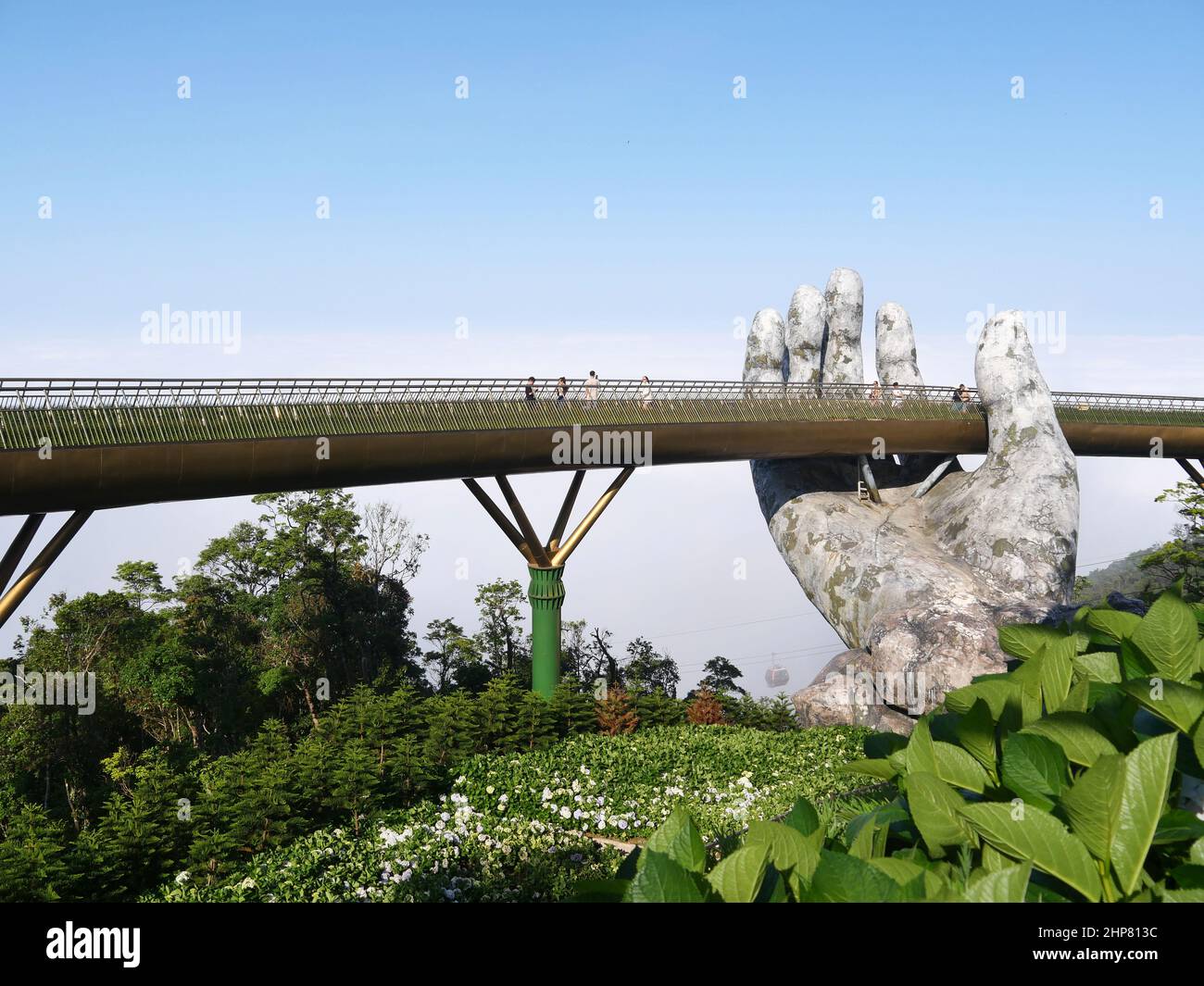 Da Nang, Vietnam - April 12, 2021: Golden Bridge lifted by giant hands in Ba Na Hills, a famous theme park and resort in Central Vietnam Stock Photo