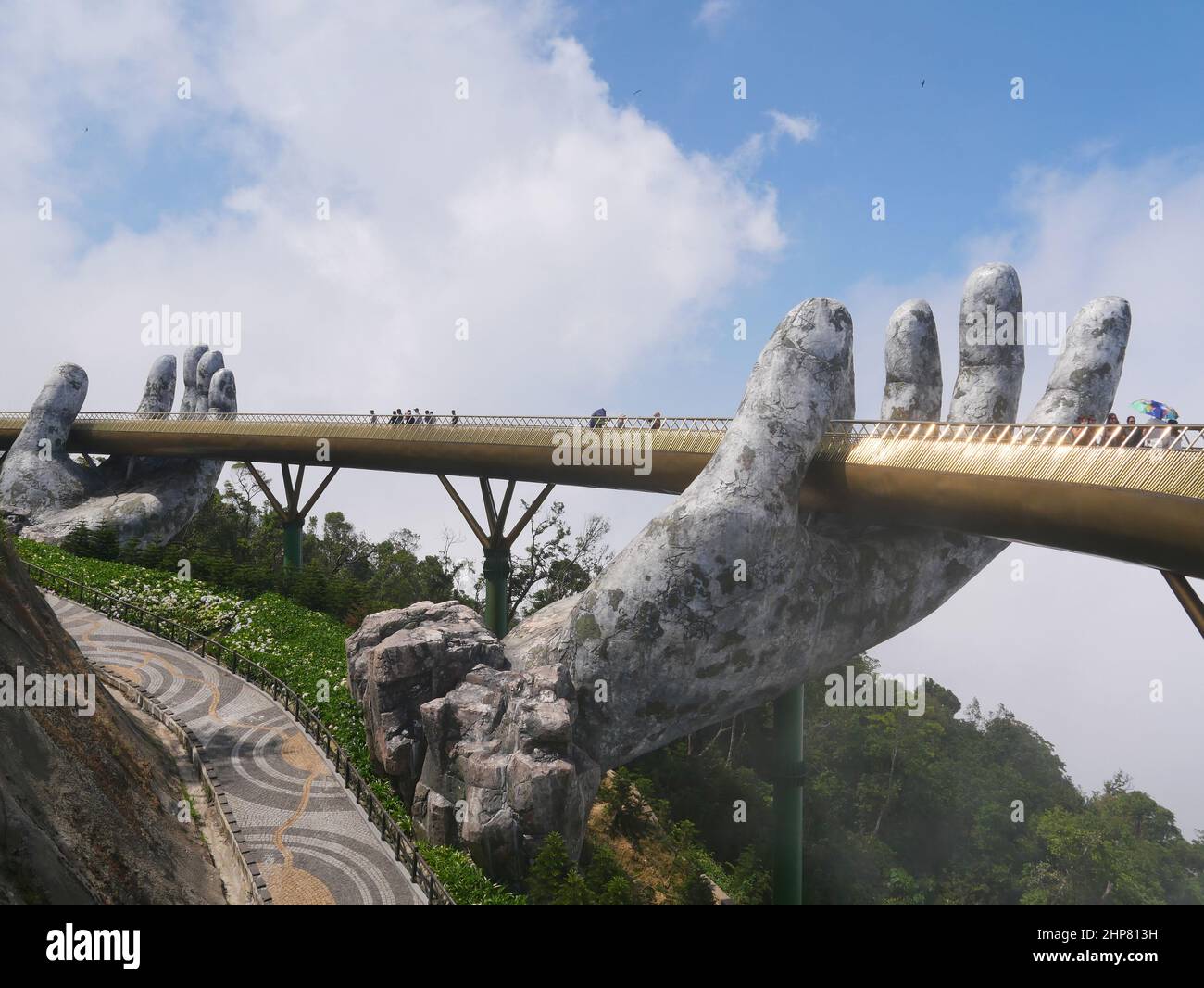 Da Nang, Vietnam - April 12, 2021: Golden Bridge lifted by giant hands in Ba Na Hills, a famous theme park and resort in Central Vietnam Stock Photo