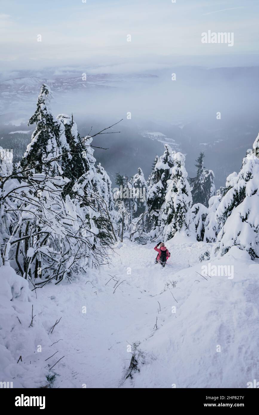 Winter Steep Slope Path Down the Mountain with Snow and person Stock Photo