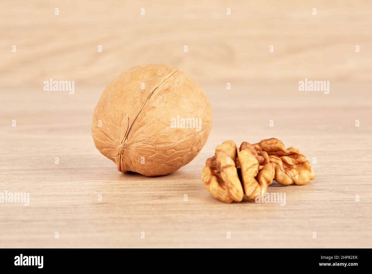 The walnut is whole, and next to it lies a peeled walnut Stock Photo ...