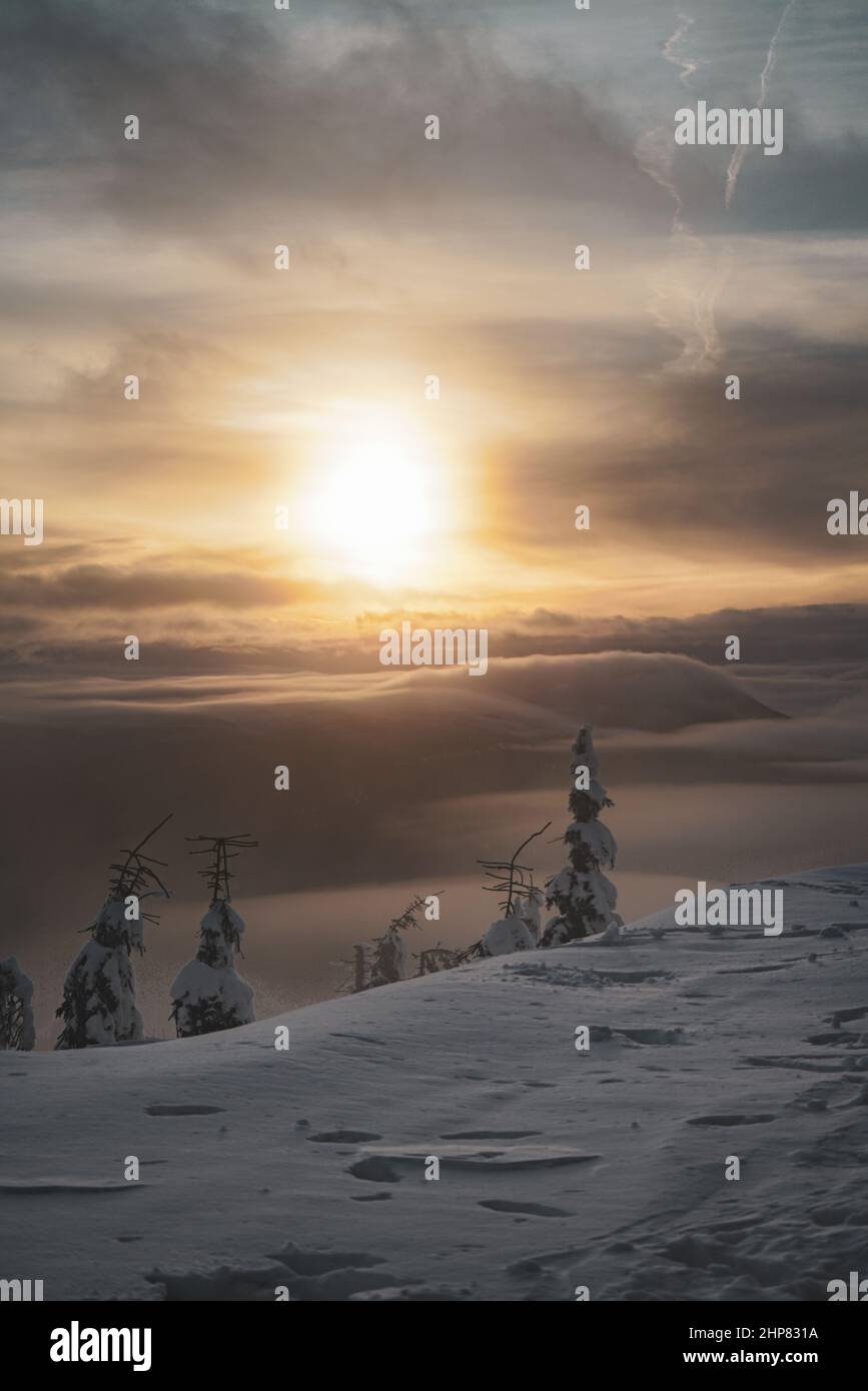 Mountain Peak Sunset With Inversion Low Clouds and Frozen Trees Stock Photo