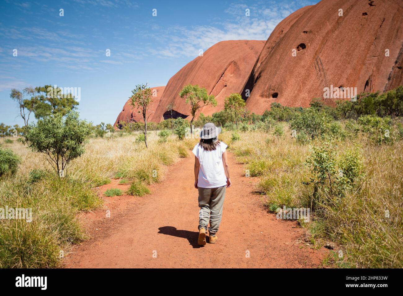 Australia, Sept 22, 2016: Woman walking in the red center,Uluru,Northern Territory Stock Photo