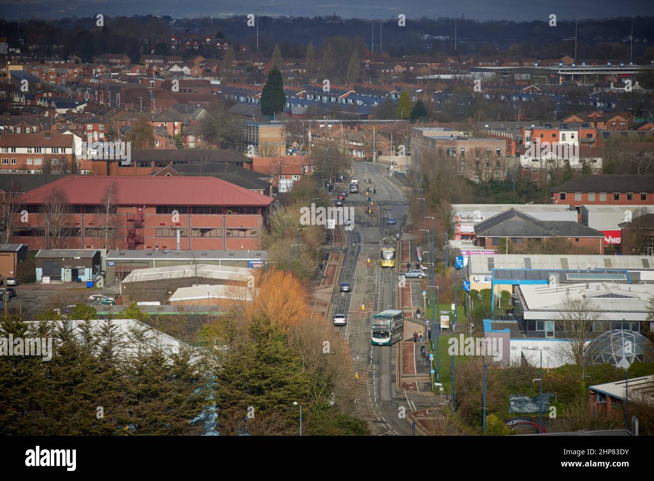 Metrolink tram on South Langworthy Road, Salford , with the houses