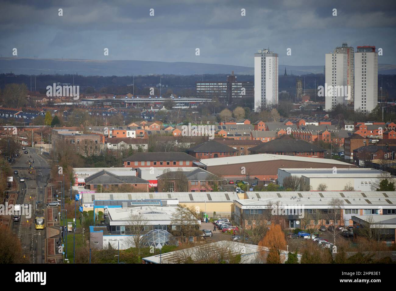 Metrolink tram on South Langworthy Road, Salford , with the houses rooftop skyline beyond Stock Photo