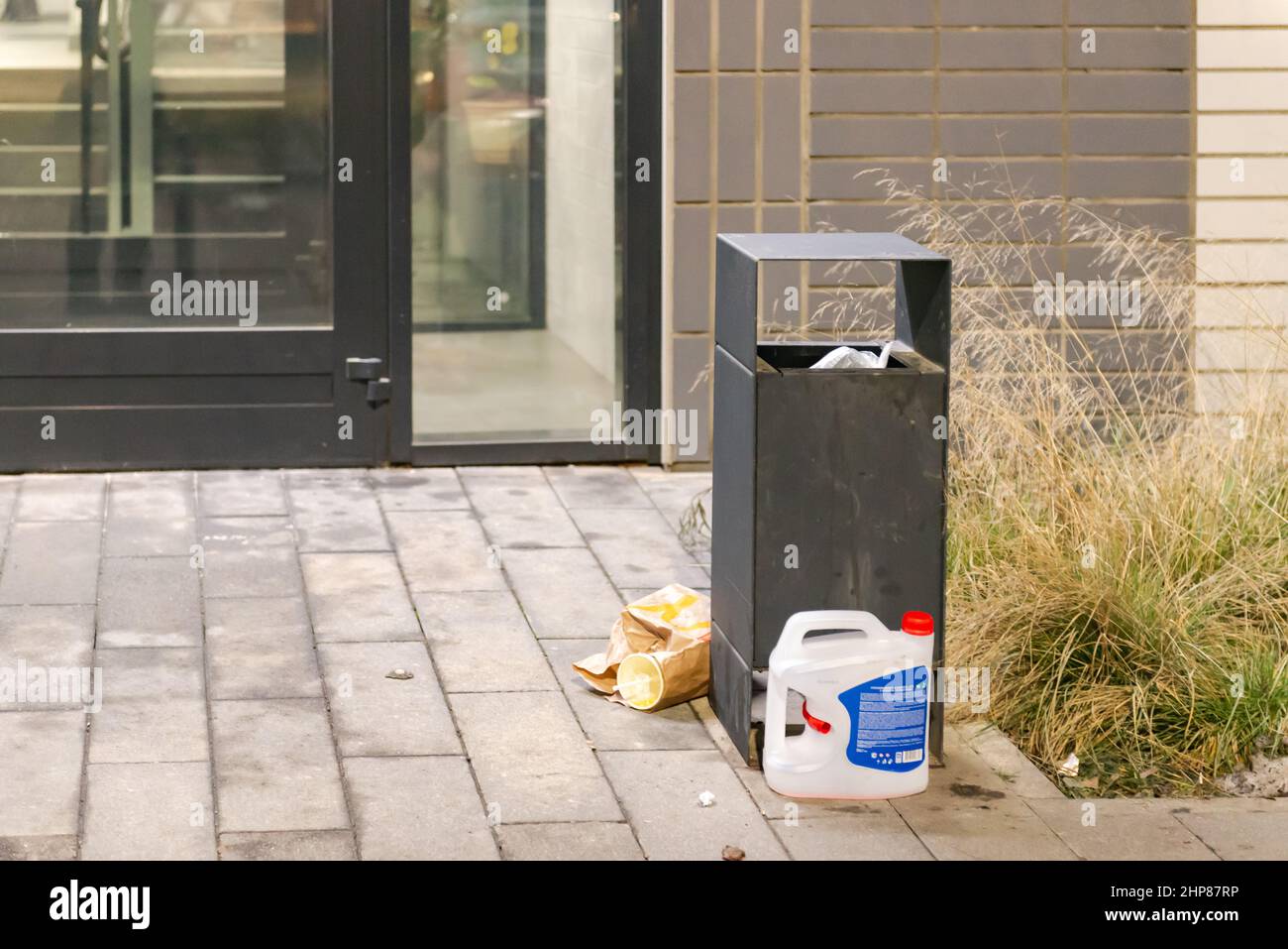 Garbage bins in the yard. An overflowing urn near the entrance of an ...