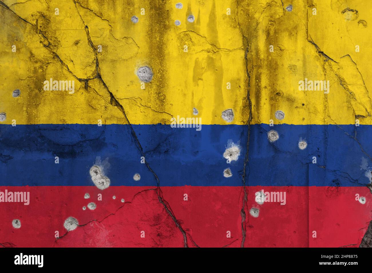Full frame photo of a weathered flag of Colombia painted on a cracked concrete wall with bullet holes. Colombian conflict and war on drugs concept. Stock Photo