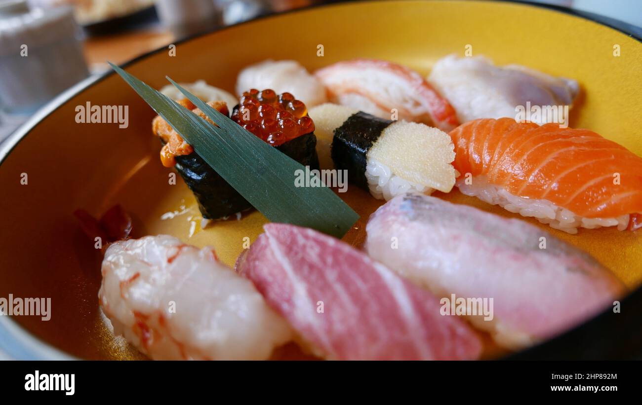a photo of a sushi dish. it was freshly made by the Japanese chef at the local restaurant in Hokkaido, Japan. botan ebi and otoro are my favorites. Stock Photo