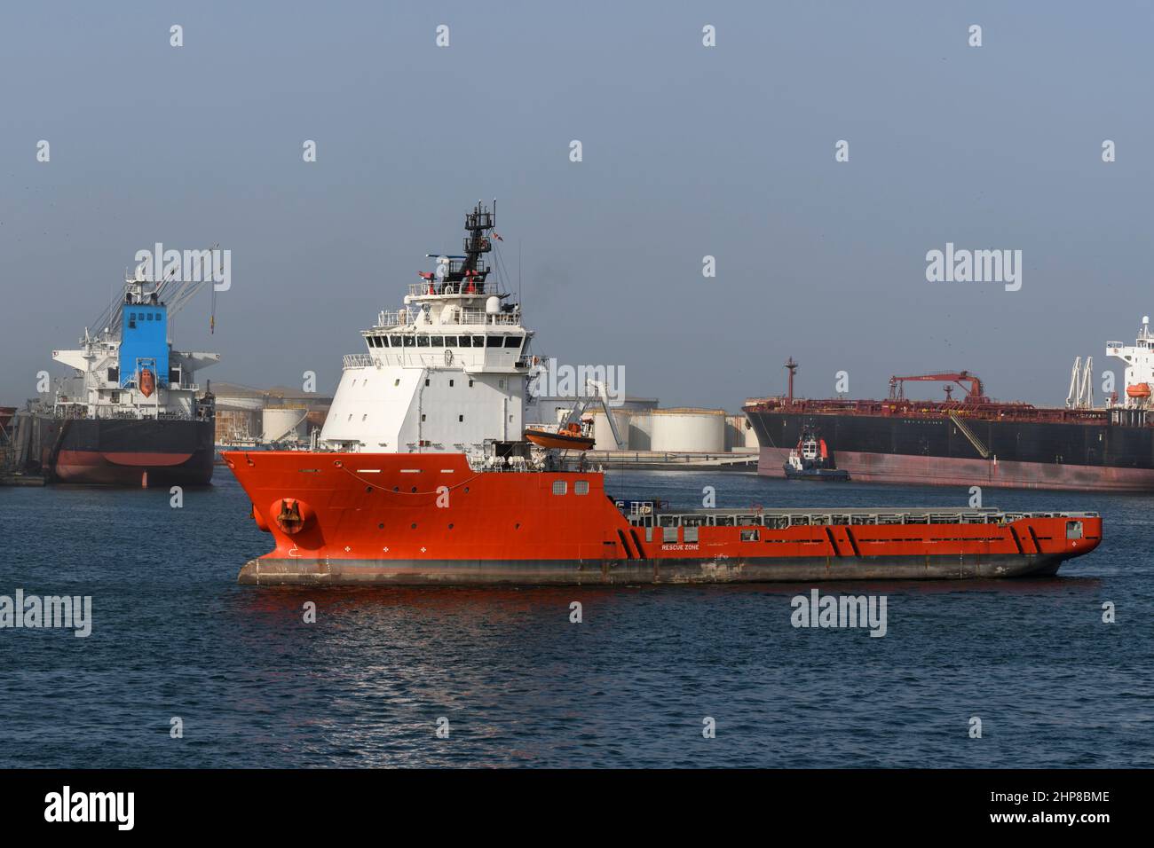 Big orange offshore supply vessel in the port. AHTS ship. Stock Photo
