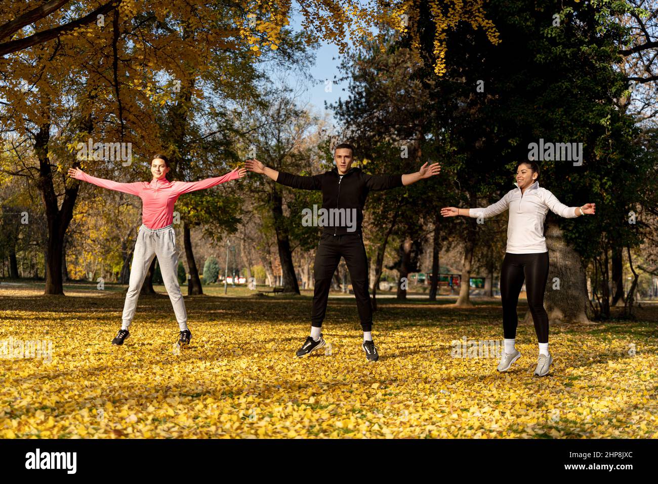 Three amazing and attractive fit friends are doing a jumping jet