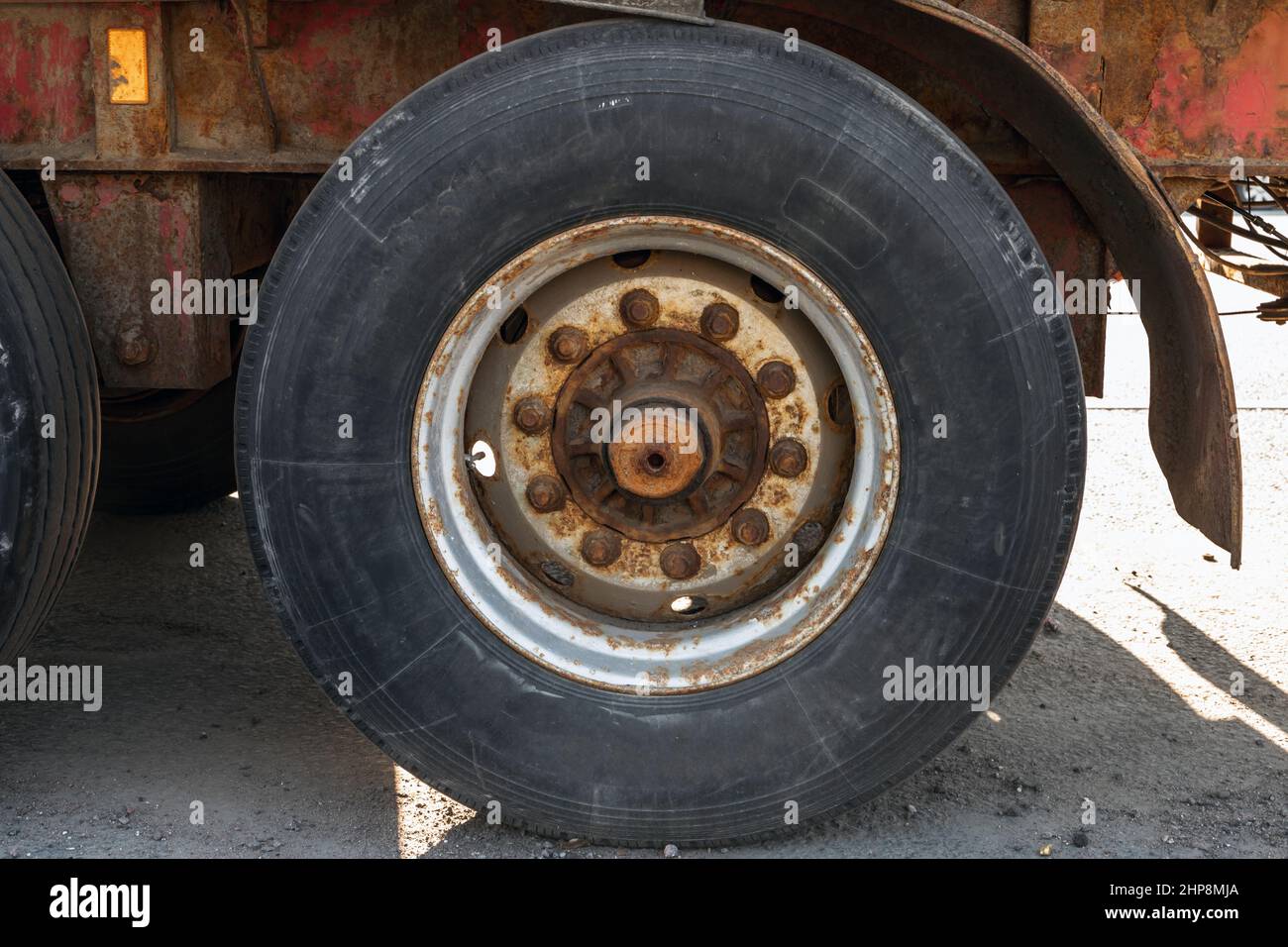 Old rusty truck wheel, close up photo Stock Photo