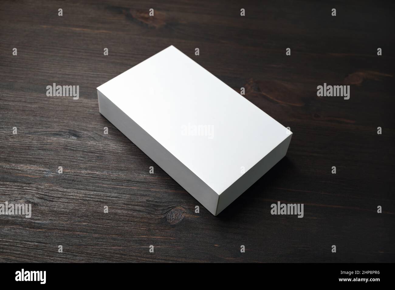 Blank box mock up on wood table background Stock Photo - Alamy