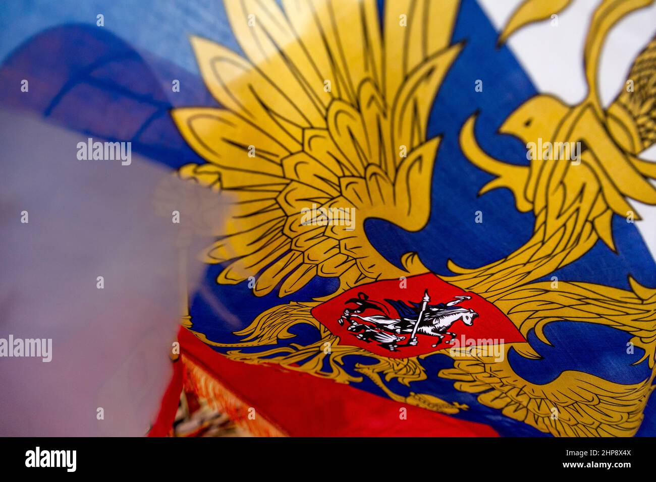 The national flag of the Russian Federation with coat of arms flutters in a wind Stock Photo