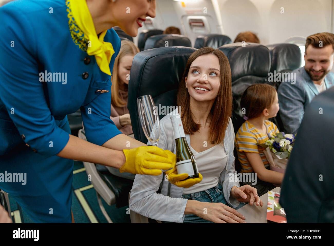 https://c8.alamy.com/comp/2HP8XX1/stewardess-giving-champagne-to-joyful-woman-in-airplane-2HP8XX1.jpg
