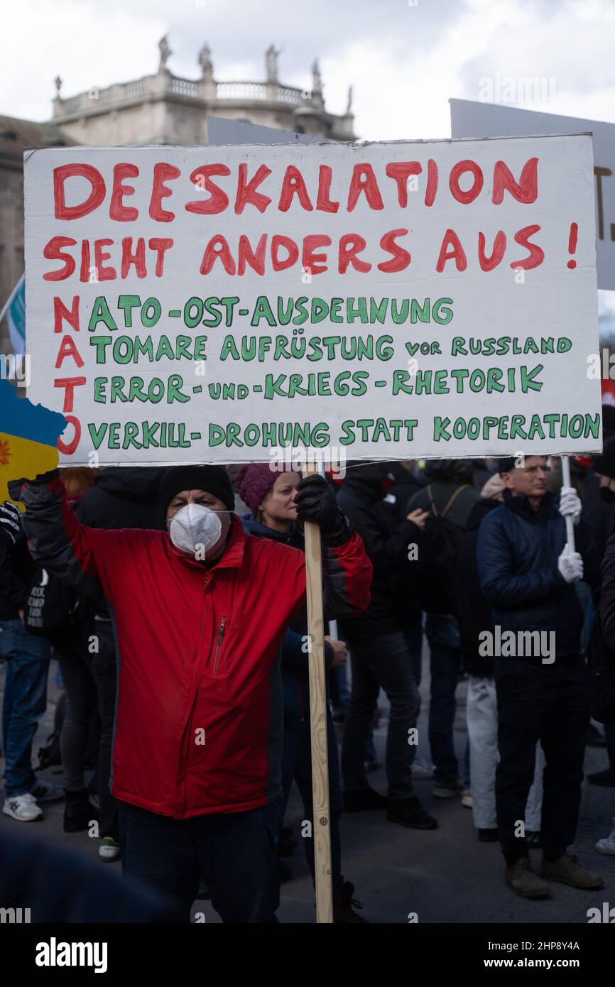 Munich, Germany. 19th Feb, 2022. Participant with sign „De-escalation looks different. nato= Nato east from stretching, nuclear armament before Russia, terror and war retoric, overkill threat instead of cooperation.“. On February 19, 2022, thousands of participants gathered to demonstrate against the Security Conference in Munich. (Photo by Alexander Pohl/Sipa USA) Credit: Sipa USA/Alamy Live News Stock Photo