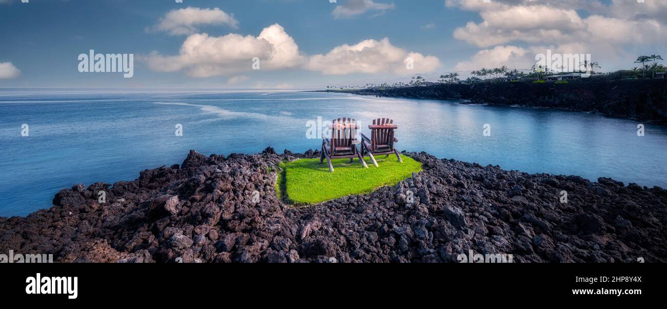 Two chairs on grass in AA lava . Hawaii, The Big Island Stock Photo