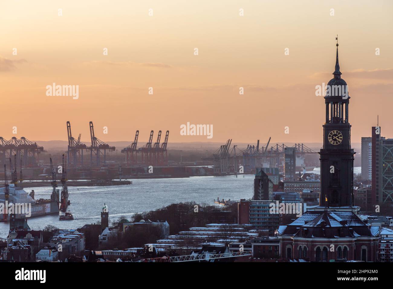view of the michel church tower and the port of hamburg in the evening light Stock Photo