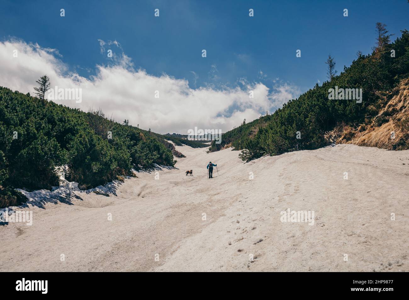 A group of people walking down a dirt road Stock Photo - Alamy